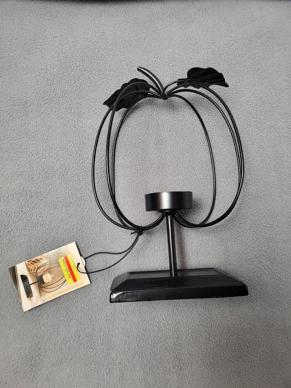 Metal Pumpkin-Shaped Candle Holder With A Wire Frame and Leaf Accent